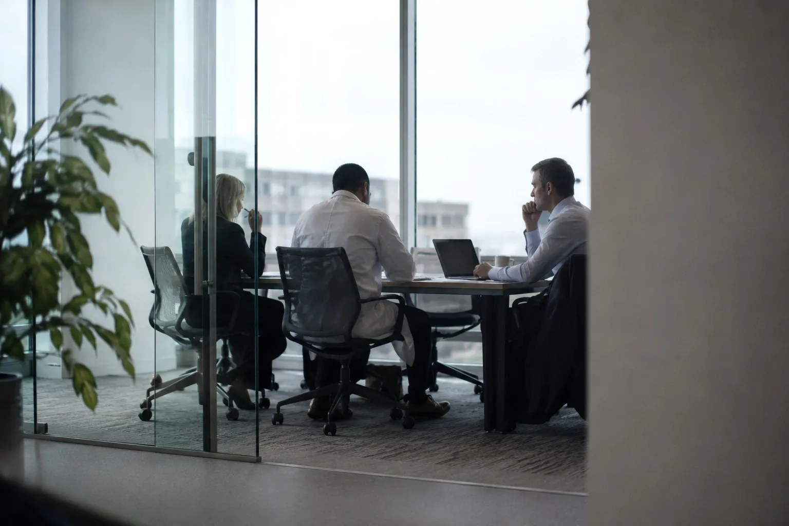 Physician and consultants reviewing research in a meeting room